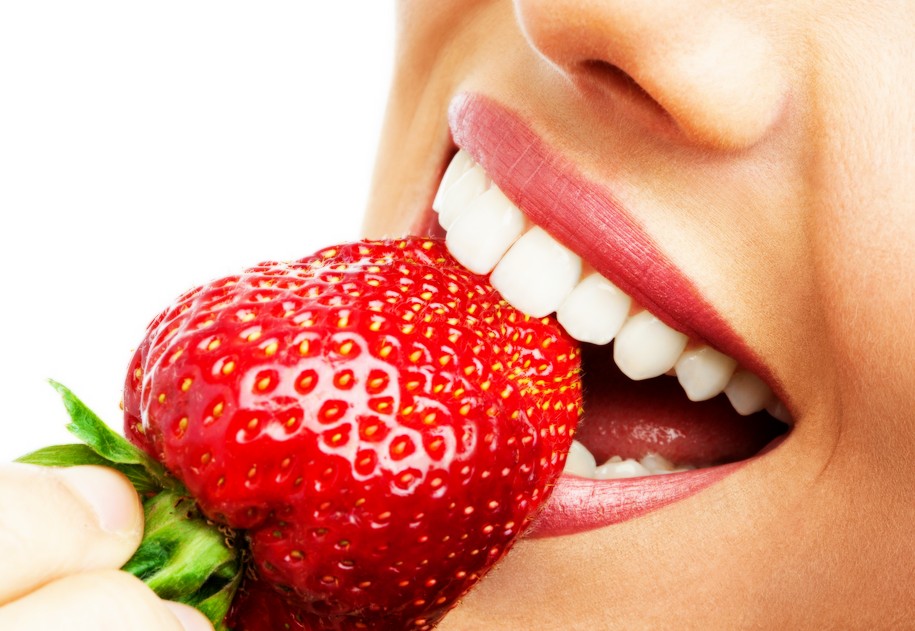 Girl eating strawberry