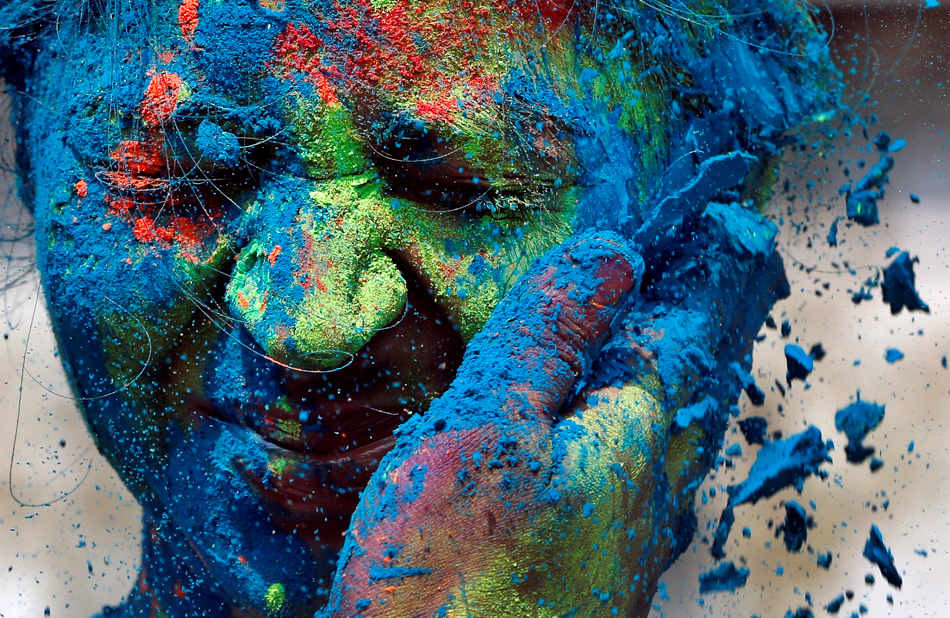 Colorful Holi Photography A man smears the face of a woman with colors during celebrations marking Holi, the Hindu festival of colors, in Mumbai, India, Monday, March 17, 2014. The holiday, celebrated mainly in India and Nepal, marks the beginning of spring and the triumph of good over evil. (AP Photo/Rajanish Kakade)