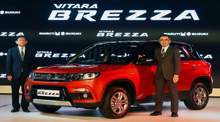 Greater Noida: Maruti officials pose with compact SUV Vitara Brezza at its launch at Auto Expo 2016 in Greater Noida on Wednesday. PTI Photo by Kamal Singh(PTI2_3_2016_000058A)