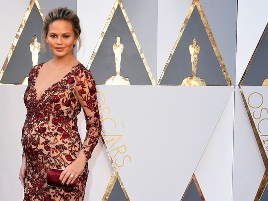 Chrissy Teigen flaunting her baby bum on Red Carpet Oscars